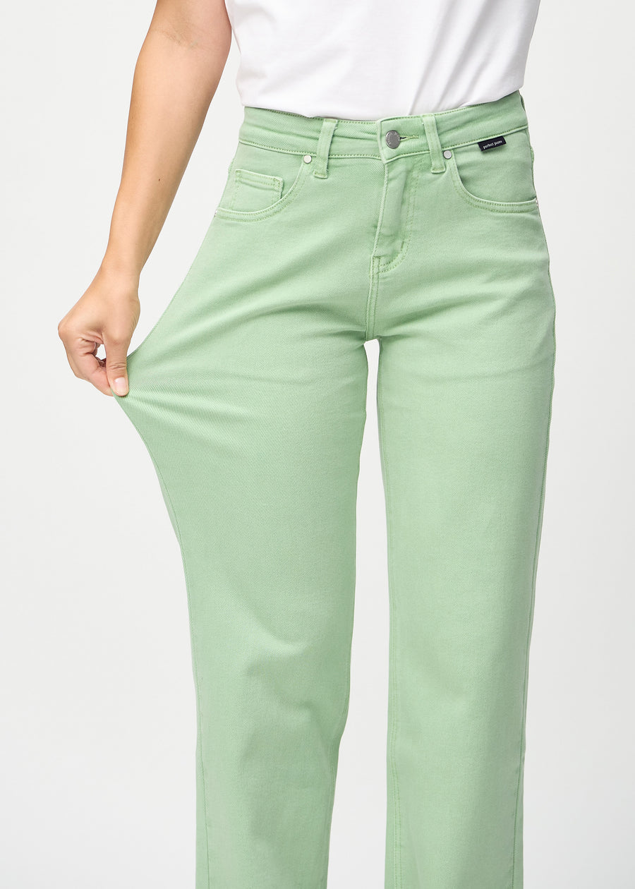 Model strækker jeansene ved låret for at vise stretch.