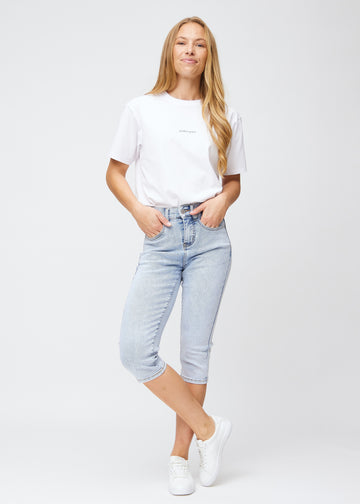 Fuldt billede af model iført lyseblå denim slim capris.