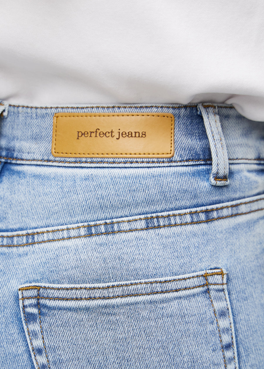 Close-up of light blue denim with Perfect Jeans leather patch at the back waistband.