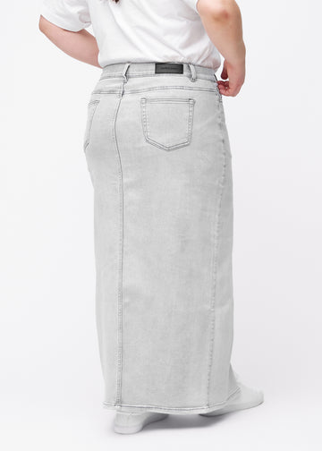 Lang, lysegrå denimnederdel i farven Ashes med regulær pasform set bagfra på plus-size model, så hele nederdelens længde kan ses.