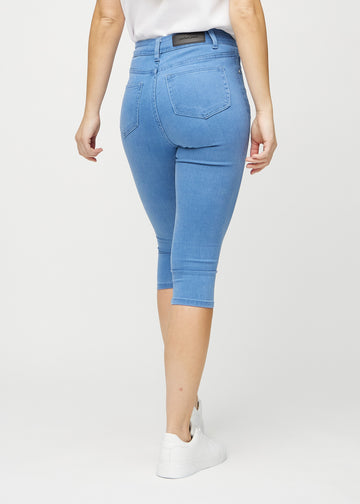 Blue skinny capris seen from the back, so the full product can be seen.