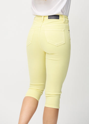 Woman wearing light yellow Lemonades skinny capris from Perfect Jeans, seen from behind.
