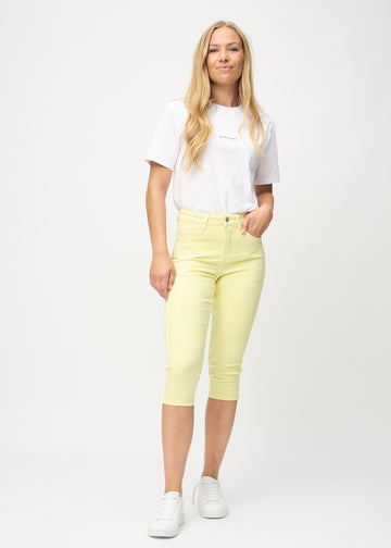 Woman wearing light yellow Lemonades skinny capris from Perfect Jeans.