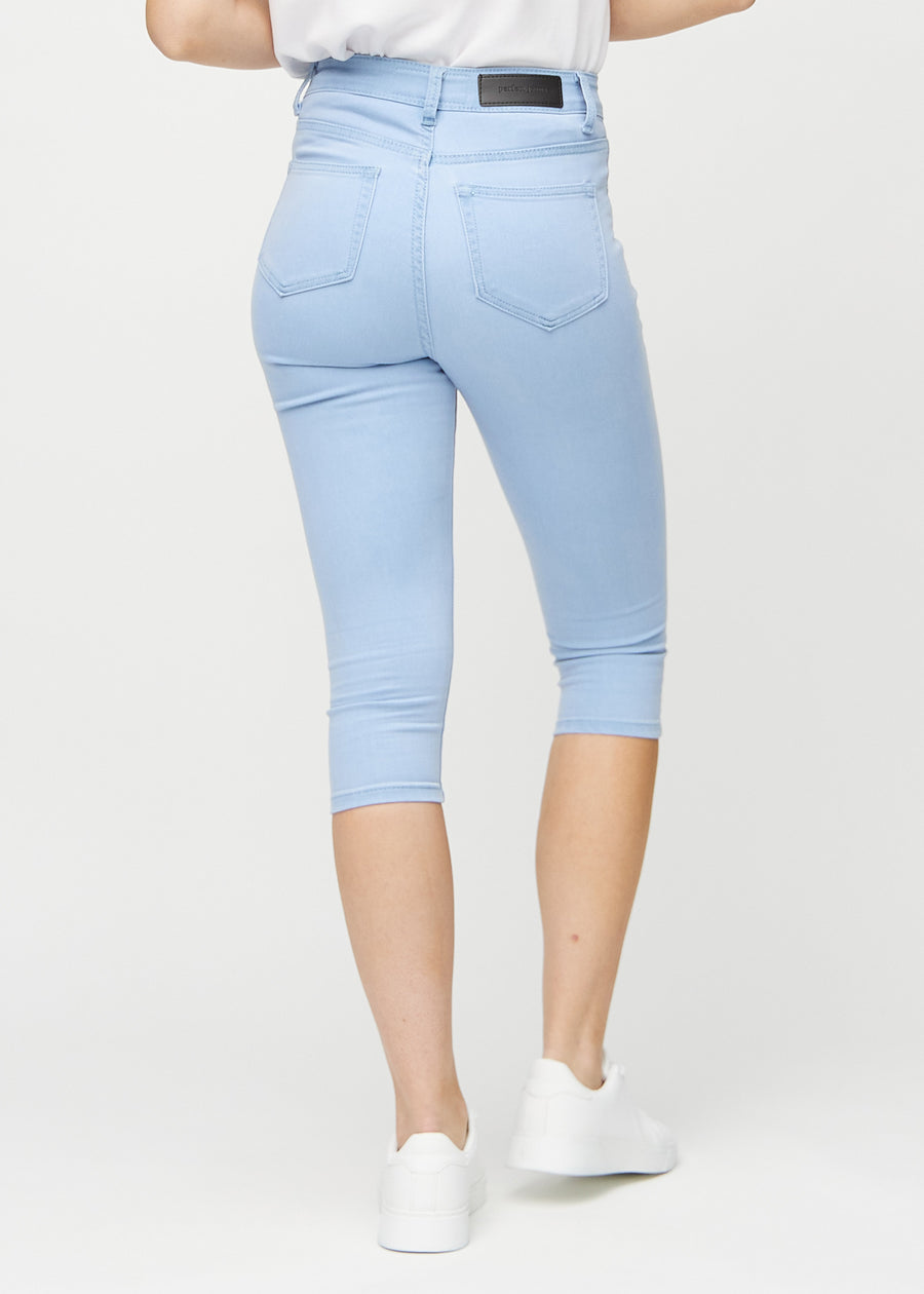 Light blue skinny capris seen from the back, so the entire product can be seen.