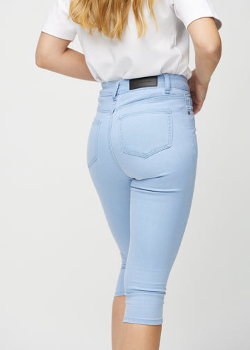 Light blue skinny capris seen from the back close up to show details.