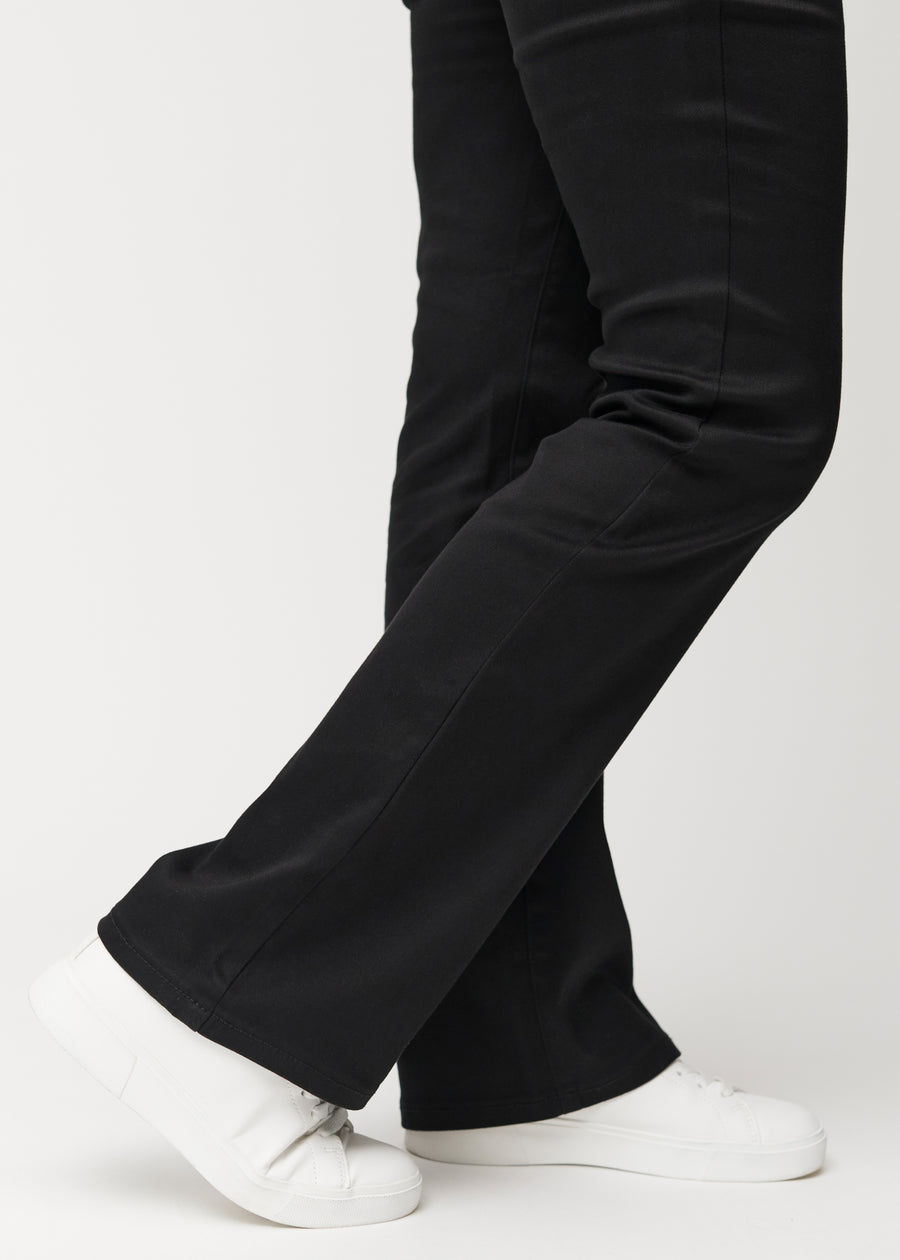 The ankles of a model, so the slight flare in the pant leg can be seen, in a Bootcut fit.