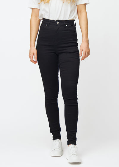 A model showcases classic black Ravens high rise skinny jeans for women, seen from the front.