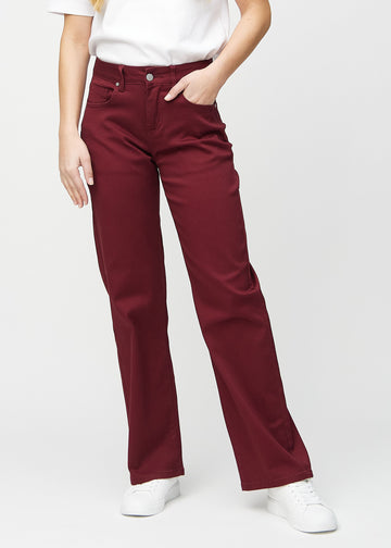 Loose jeans for women in dark red, color Santas. Front view on a model, showing the roomy, wide-leg fit.