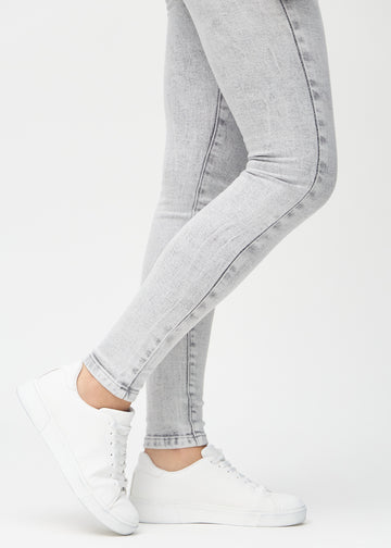 The ankles of a model, so you can see how tightly the jeans fit.