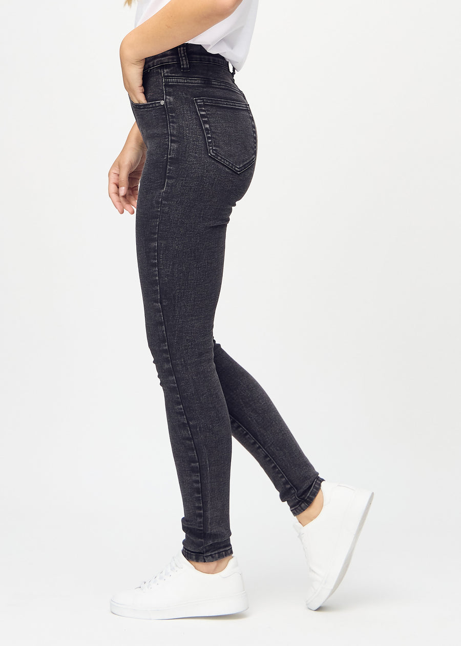 Skinny jeans for women in dark grey, color Shadows. Side view on a model.