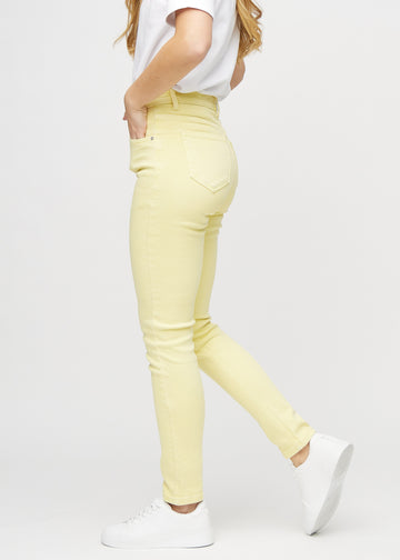 Slim jeans for women in light yellow, color Lemonades. Side view on a model.