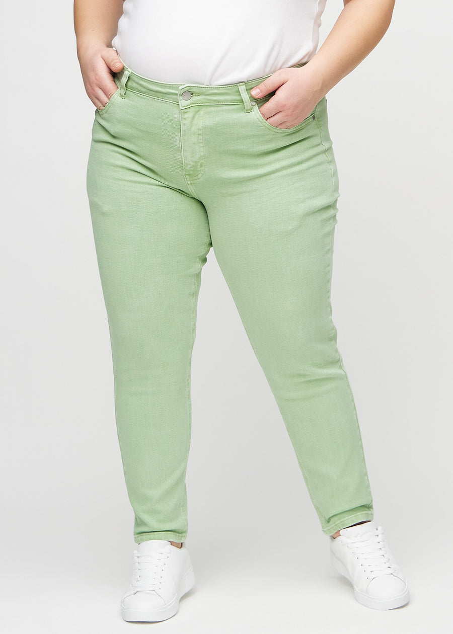 Slim jeans for women in light green, color Mints. Front view on a plus-size model, showing a close fit through the leg with a little more room at the ankle.