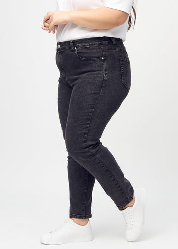 Slim jeans for women in dark grey, color Shadows. Side view on a plus-size model.