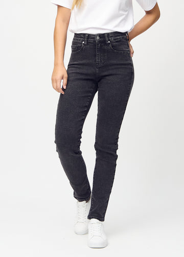 Slim jeans for women in dark grey, color Shadows. Front view on a model, showing a close fit through the leg with a little more room at the ankle.