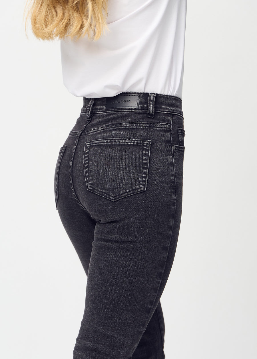 Slim jeans for women in dark grey, color Shadows. Close-up back view on a model, showing the details.