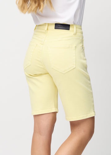 Light yellow regular middle shorts seen from the back close up to show details.