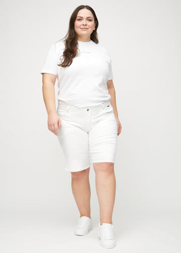 Full image of a plus-size model in white regular middle shorts.