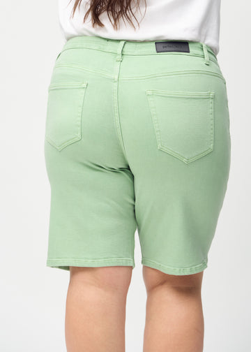 Light green regular middle shorts seen from the back close up on a plus-size model to show details.