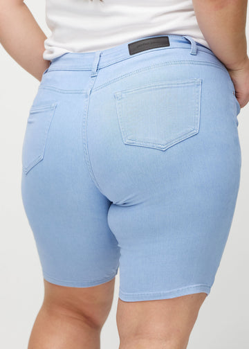 Light blue skinny middle shorts seen from the back close up on a plus-size model to show details.