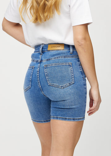 Denim skinny short shorts seen from the back close up to show details.