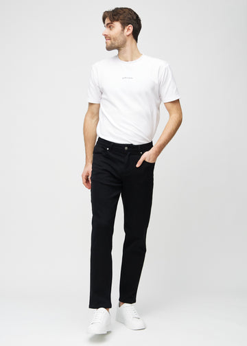 Full image of a model wearing black regular jeans.
