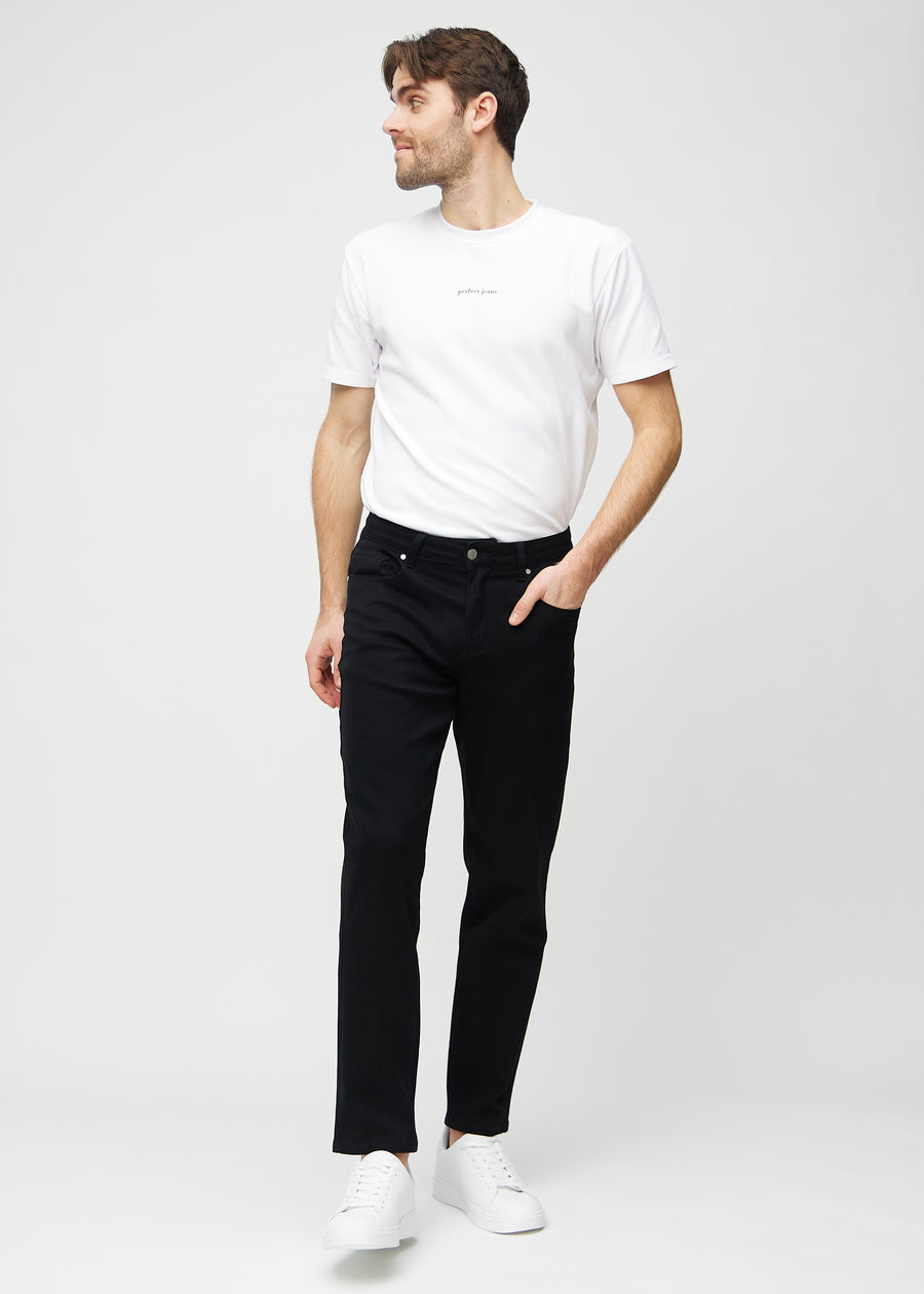 Full image of a model wearing black regular jeans.