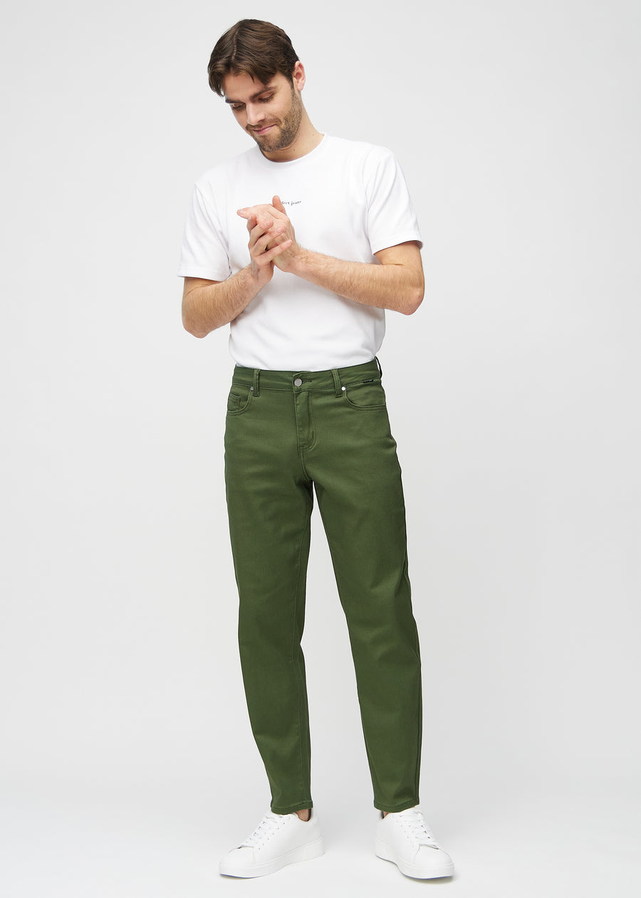 Full image of a model in dark green regular jeans.