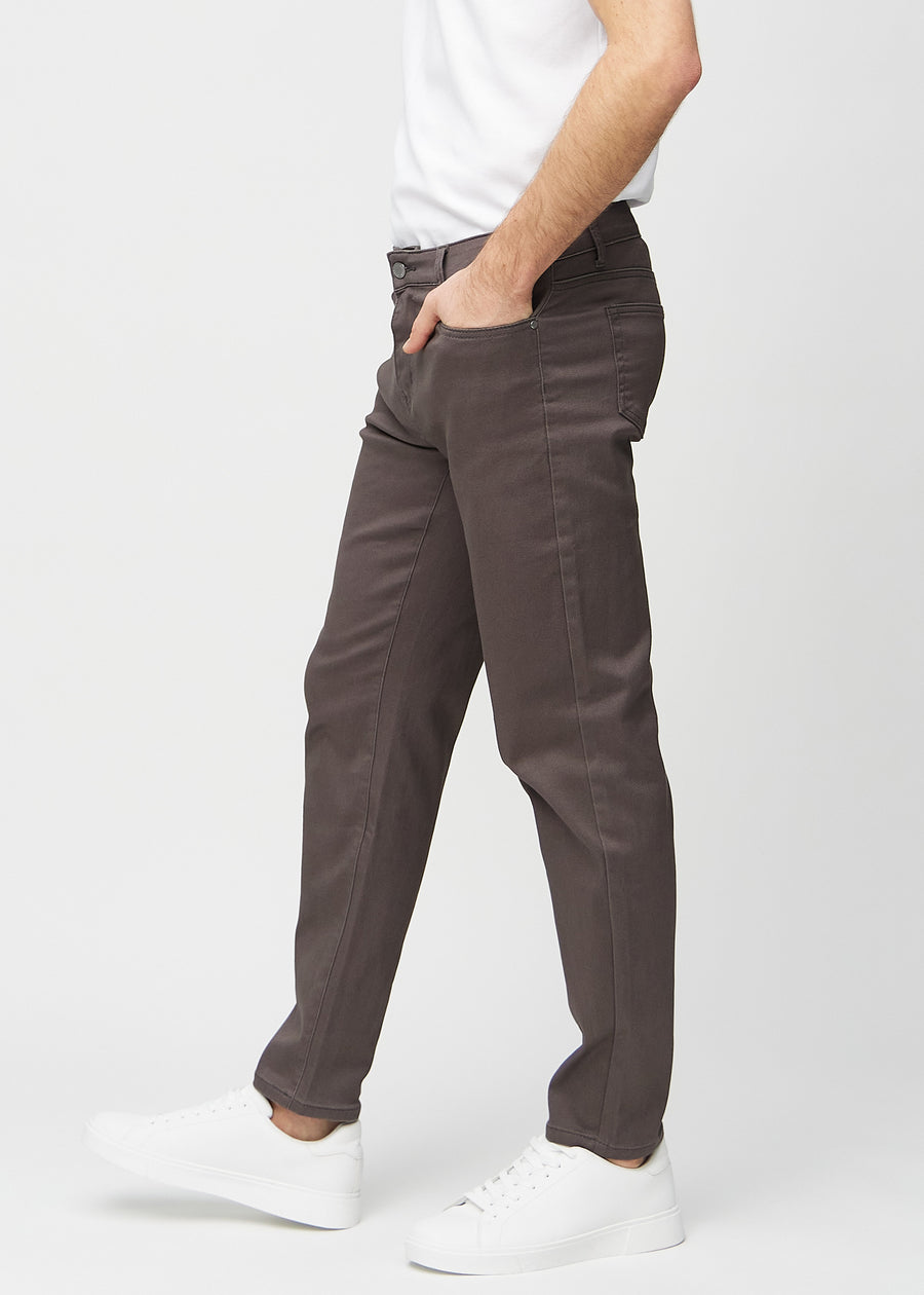 Grey-brown regular jeans seen from the side on a model.