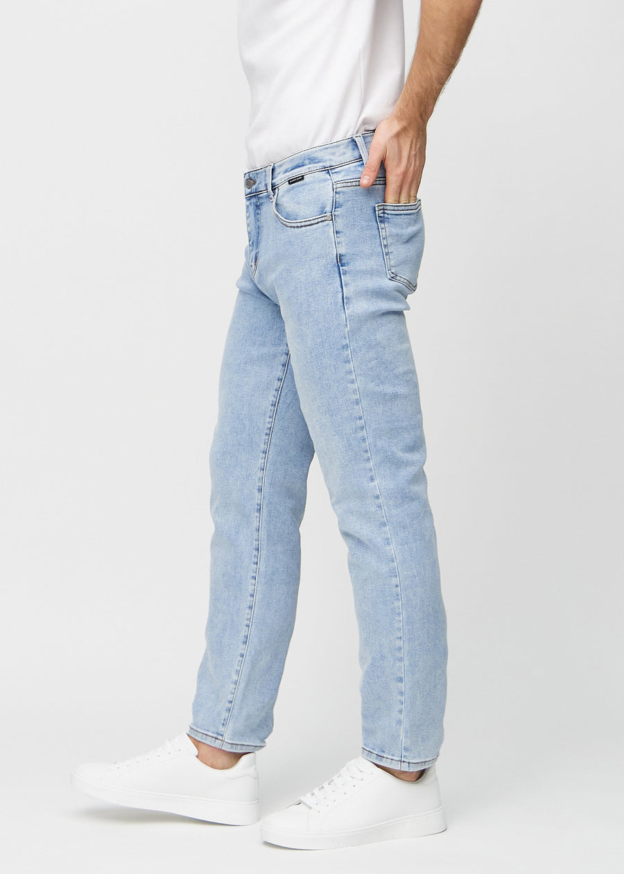 Light denim regular jeans seen from the side on a model.