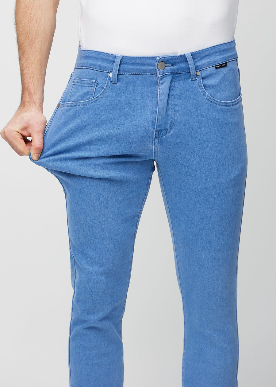Model stretches the jeans at the thigh to show the fabric&