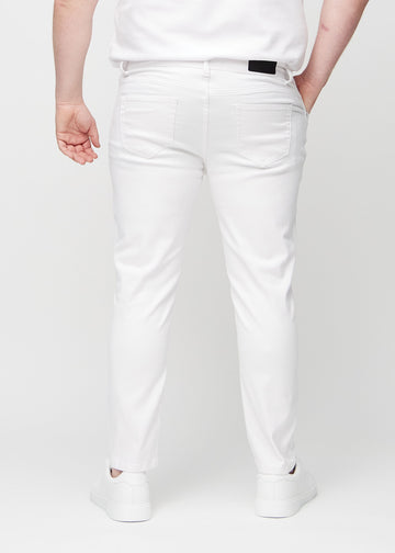 White slim jeans viewed from the back on a plus-size model to show the full product.
