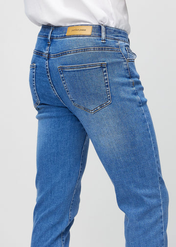 Close-up back view of blue denim slim jeans showing details.