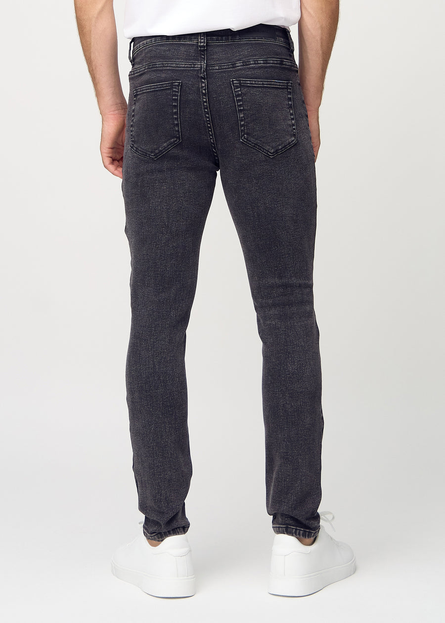 Dark grey denim slim jeans viewed from the back to show the full product.