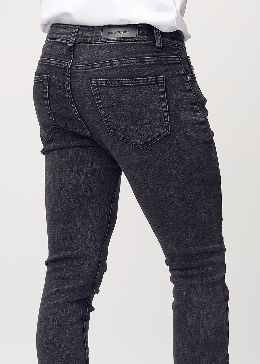 Close-up back view of dark grey denim slim jeans showing details.