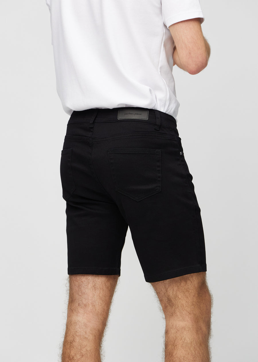 Black middle-slim shorts seen from the back close up to show details.